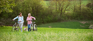 Couple in Meadow with Bikes Background Live Healthy Background Image